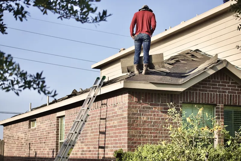 Professional roofer working on a residential roof in Upper Montvale